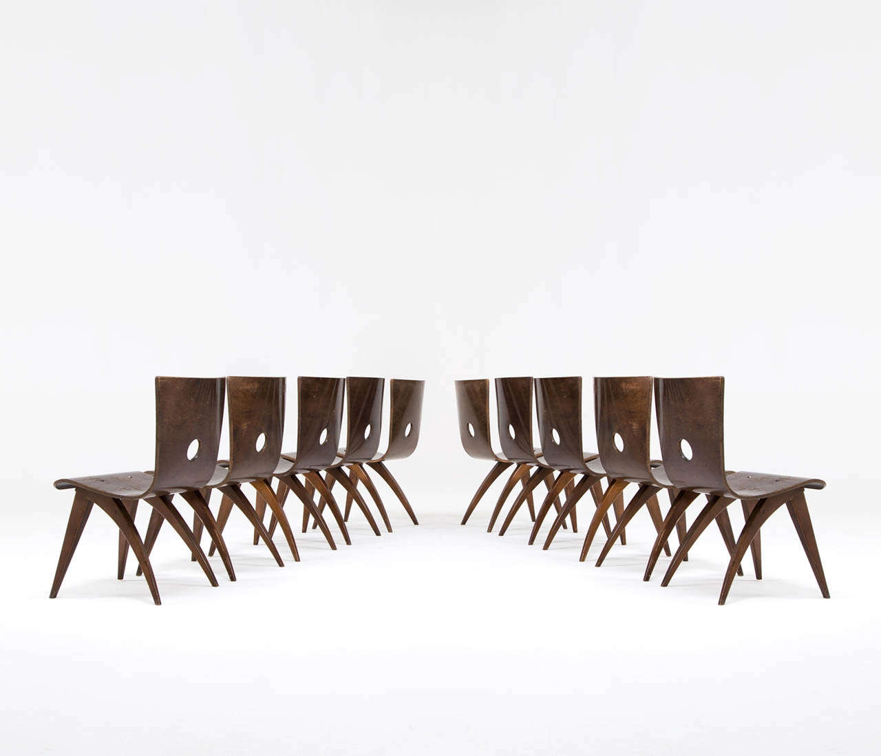 Dining room chairs, in plywood, for Van Os, the Netherlands, 1950s. 

Highly rare set of Van Os dining room chairs, made in the Netherlands during the 1950s. These chairs, made from dark stained beech plywood, are hard to find and have and