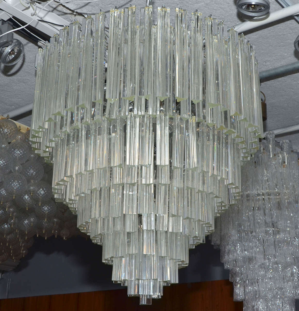 1970s chandelier by Venini. Ten rows of crystal pendants. Acquired from a Sheraton hotel (seven pieces in different size). A real vintage piece with high quality crystals. Photos of the metallic structure available on request. Wired for European use.