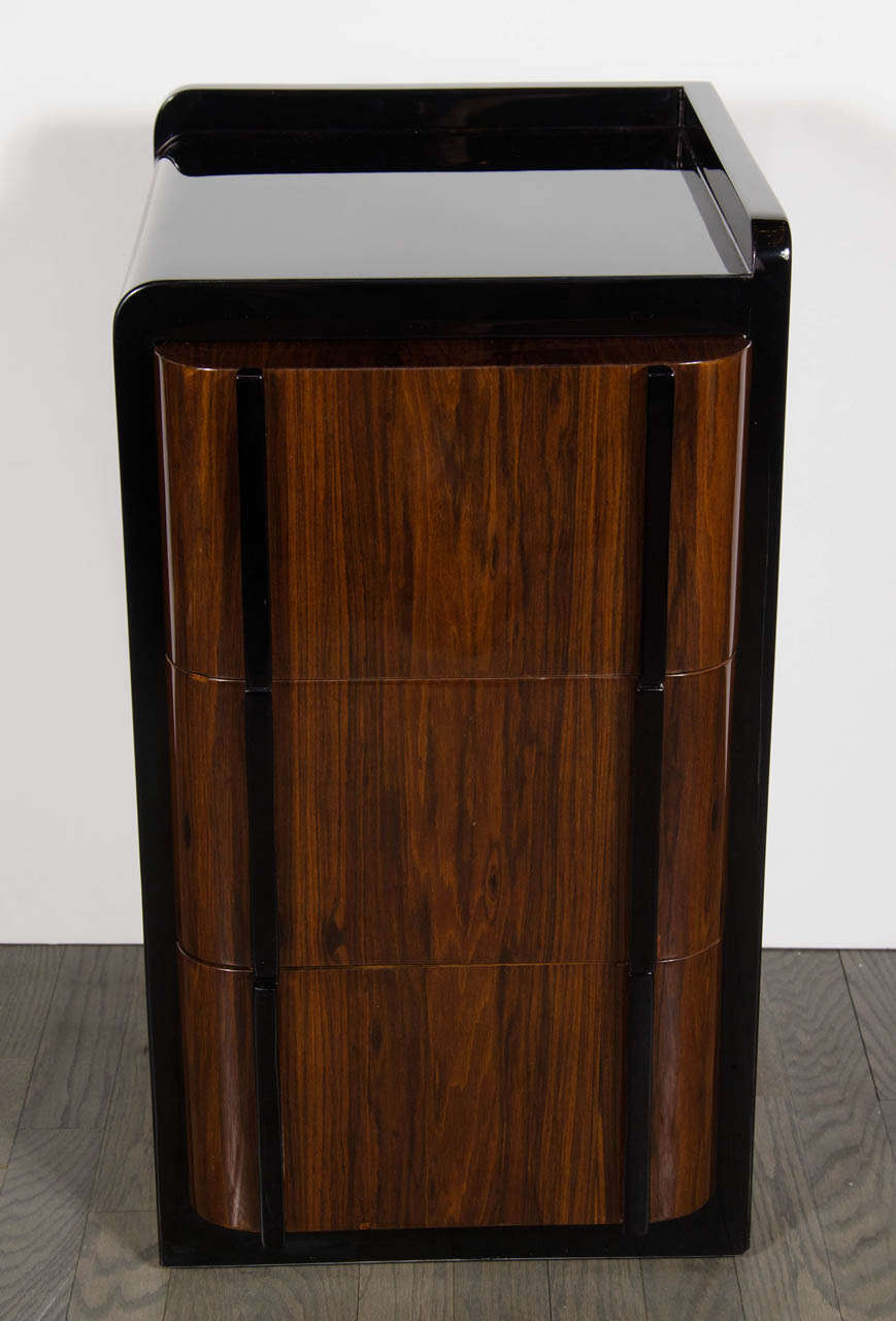 These streamlined nigh stands feature book-matched rosewood  drawers with black lacquer accents. Great Machine age design.