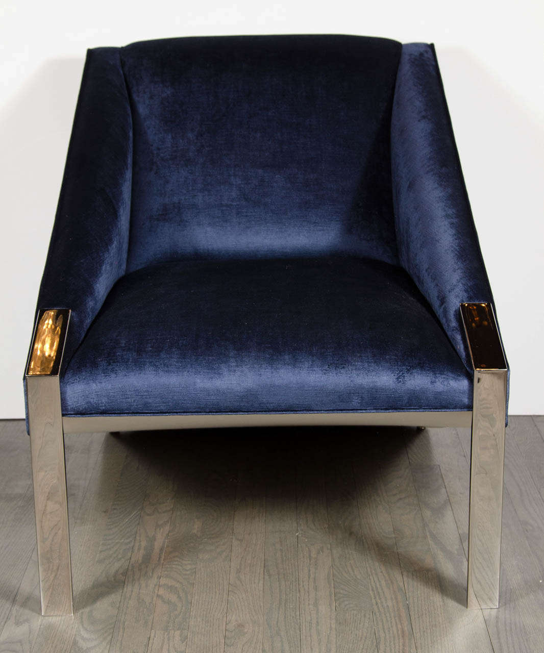 This ultra chic pair of Modernist angular club chairs attributed to Milo Baughman for Directional features slim-lined polished nickeled legs and has been newly upholstered in sapphire blue velvet.