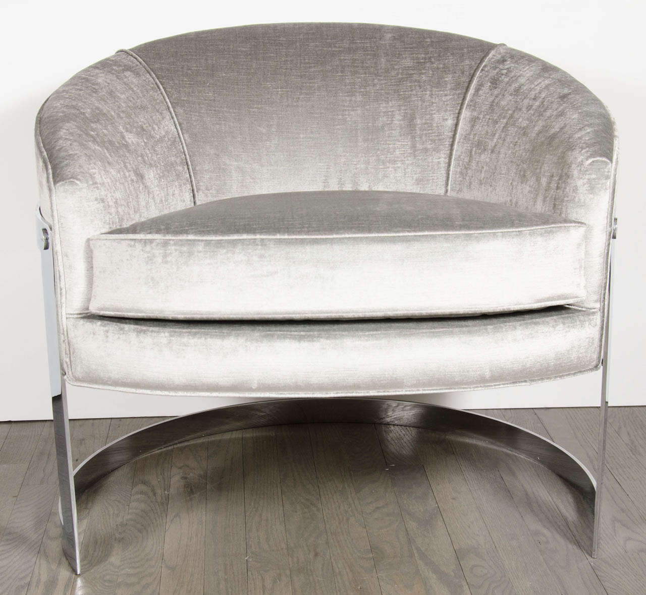 These ultra chic chairs feature a polished chromed banding detailing in a semi-circular design with have been newly upholstered in a lux silvery pearl velvet.
