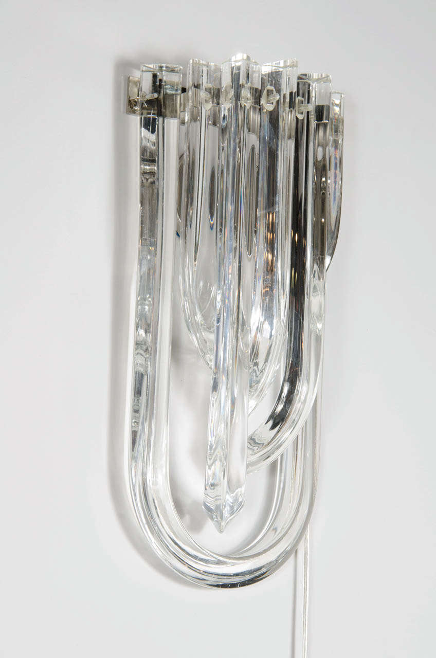 These gorgeous ribbon sconces were realized in Murano, Italy- the island off the coast of Venice renowned for centuries for its superlative glass production. Composed of overlapping curvilinear translucent Murano glass rods and fastened with chrome