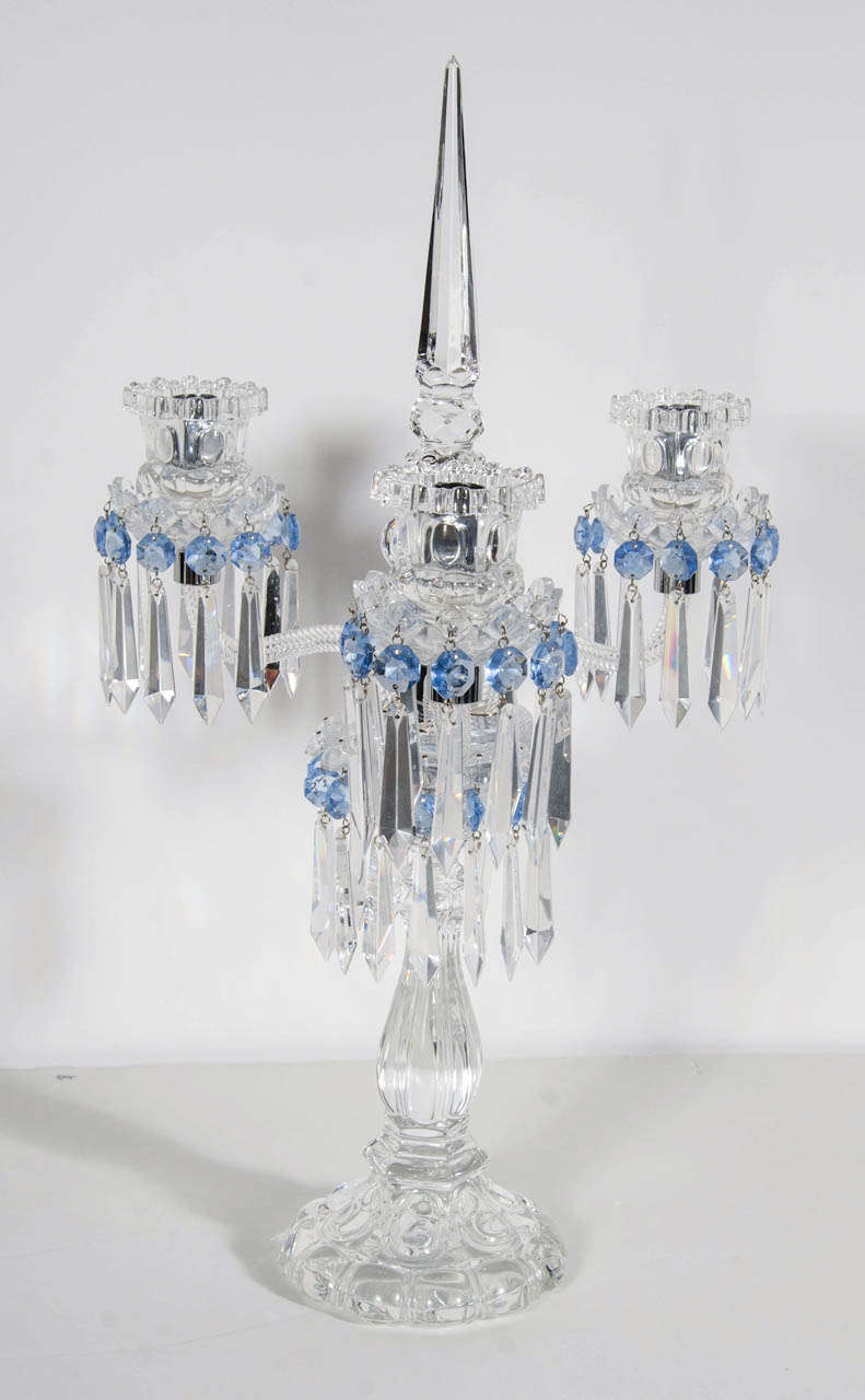 This gorgeous pair of Girandoles feature fine cut crystal pendants and pale blue cut crystal details.They have three arms with a center crystal spire as well.These are the classic baccarat style and they are also signed baccarat on the bottom of