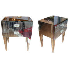 Charming pair of commodes in mirror.