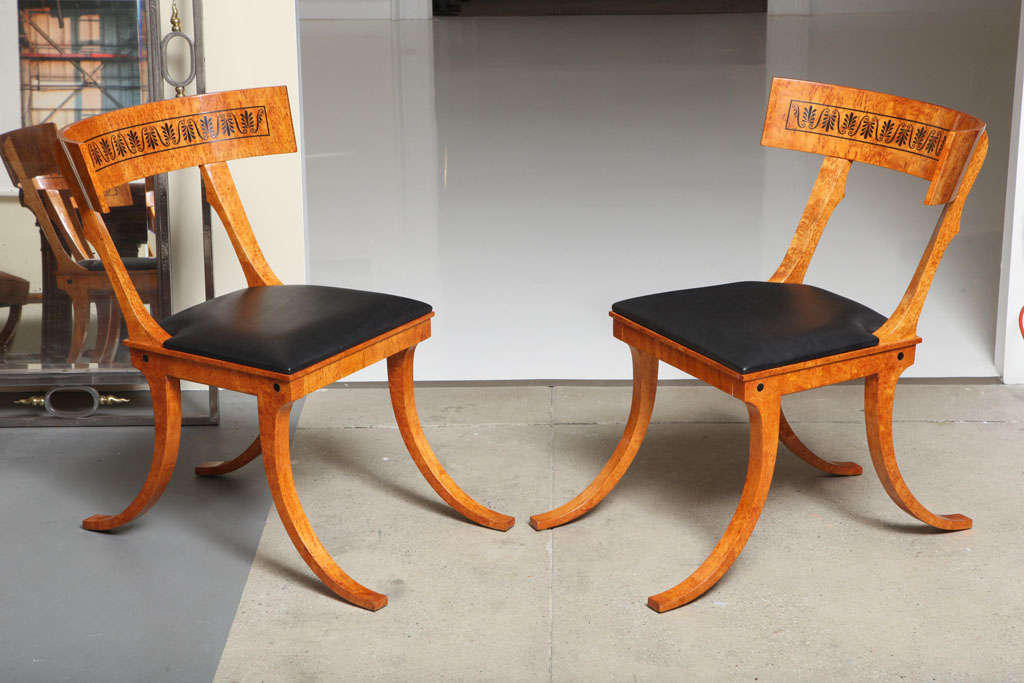 A pair of Russian Karelian birch Klismos chairs after the design from Danish painter Nikolaj Abraham Abildgaard (1743 – 1809). These chairs were produced in St. Petersburg.
A total of six chairs are available and can be purchased in pairs.