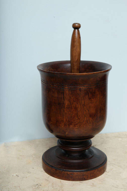 Turned lignum vitae mortar and pestle, the flared lip over three turned rings over stepped stem, the pestle of turned form, all with good rich color.  Size listed is of the mortar, pestle is 9