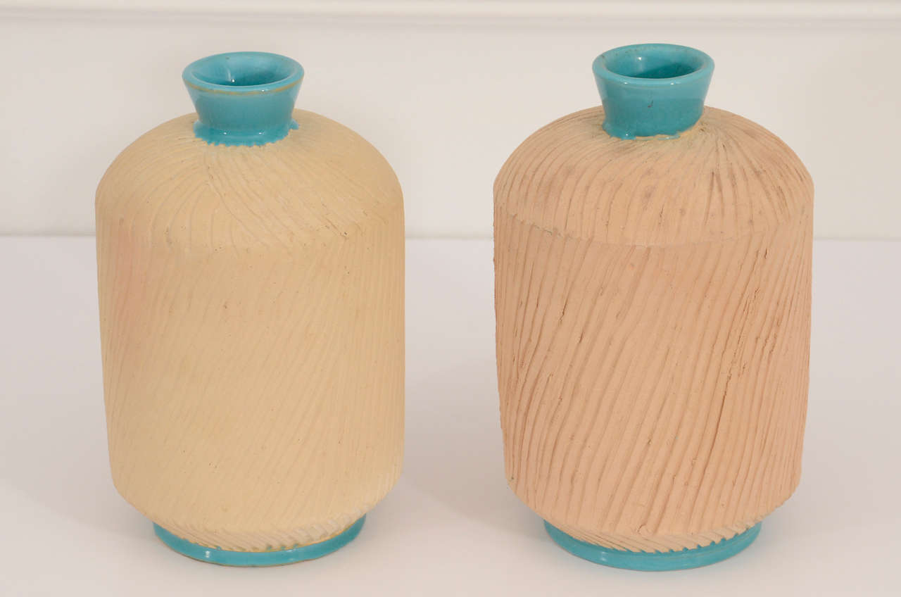 Unglazed, incised terracotta bodies with glossy turquoise contrast. Signed Italy to base. Price is for the pair.