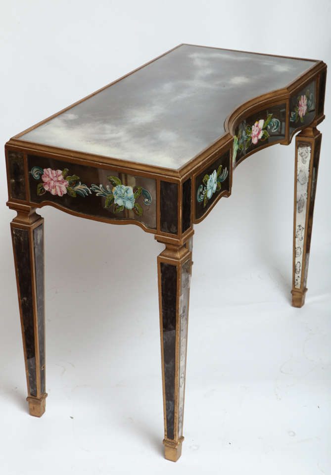 A charming eglomise three draw vanity with floral decoration