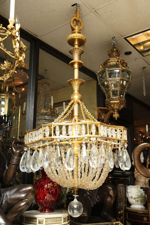 A very large and fine quality, circa 1900 bronze and crystal twelve-light chandelier attributed to Caldwell. The casting on this chandelier is of the finest and has a few very large bronze links of its original chain.
Stock Number: L23