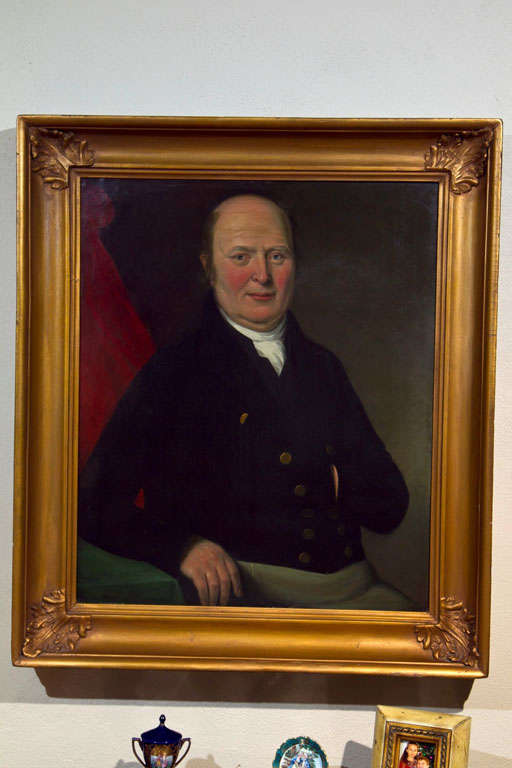 An unsigned, early 19th century oil on canvas portrait of a gentleman in a short jacket--possibly a sea captain; traditional gold frame.