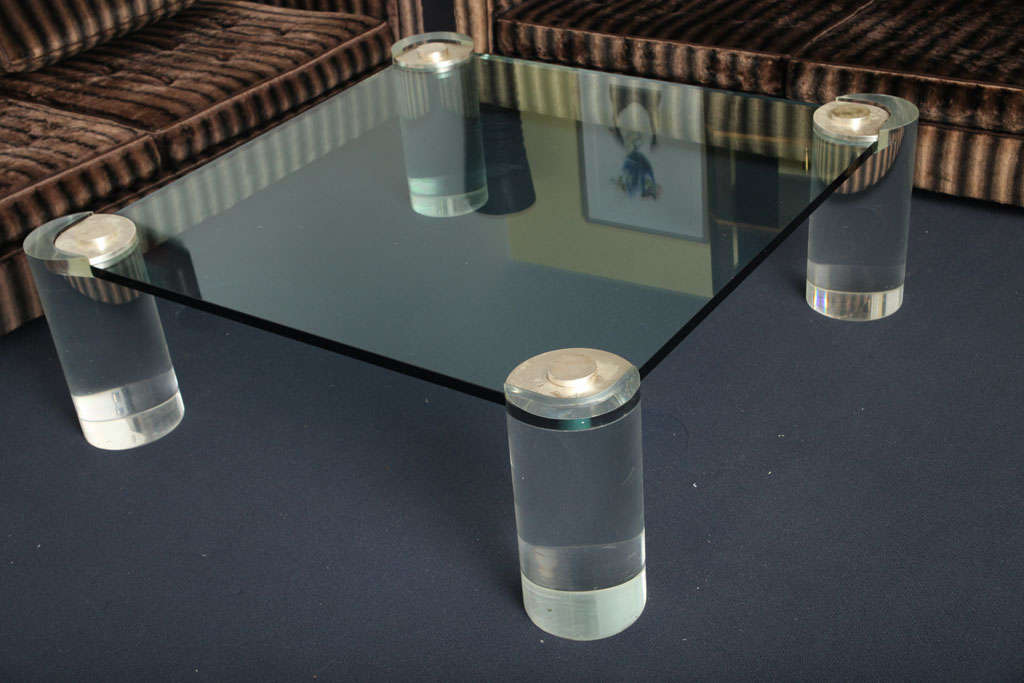 Fantastic 1970's Karl Springer coffee table crafted with solid lucite legs, <br />
glass top, brass detail at top of legs. Superb condition.
