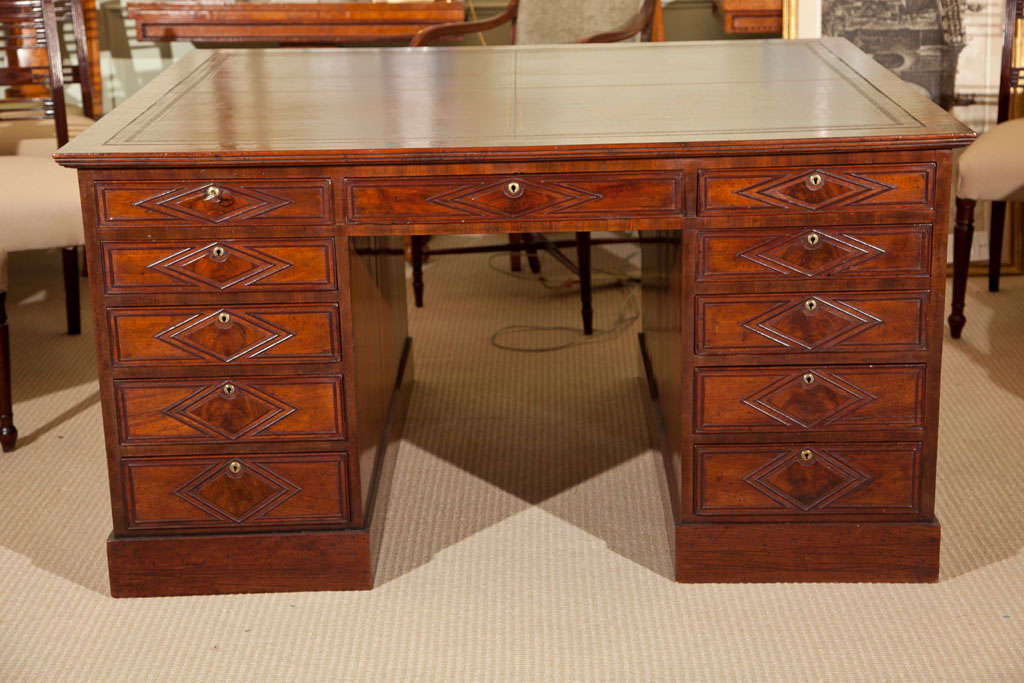 Late 19th century mahogany and leather partners desk (one piece) having interesting applied detail.