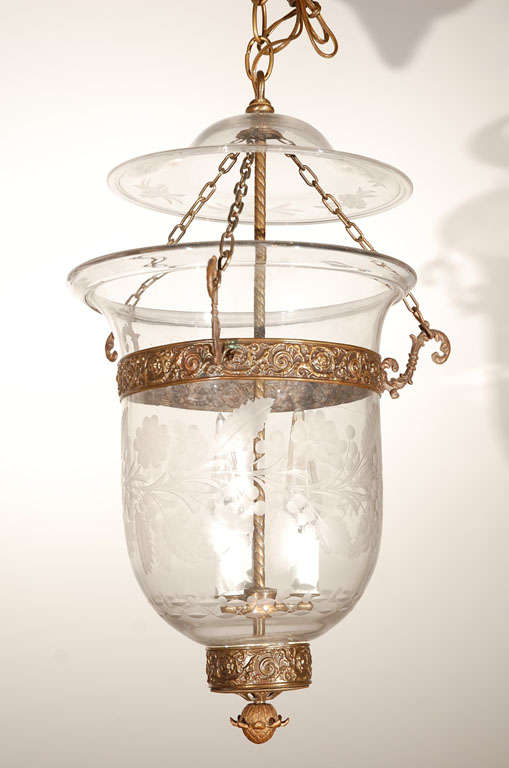 A large-scale Anglo-Indian glass 11" diameter bell jar clear handblown glass lantern with floral etching with brass fittings .
Original Bell jar hall lantern suspended by three chains the length of which can be adjusted rewired with three