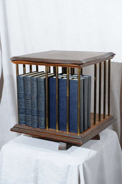 We thought we were dreaming when we saw this wonderful miniature revolving bookcase.  Put your books or your cd's in this elegant little piece.  Can be placed on the floor or a table; can also be used as an end table.  Bears a metal tag with the