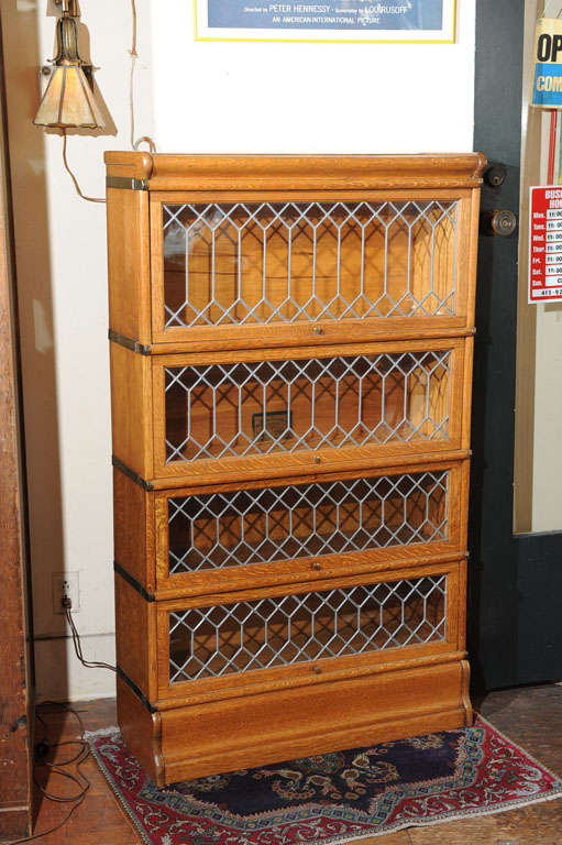 This is the lawyer's bookcase everybody is looking for. It has the beautiful bullnose top and bottom, as well as leaded glass in every section. Note that two of the sections are smaller; there is one medium-sized and one over-sized. They can be