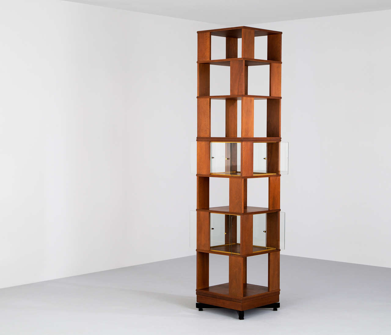 Bookcase, in wood and glass, Italy, 1960s. 

Beautiful designed tall swiveling bookcase designed in the manner of Claudio Salocchi. This Mid-Century Modern swiveling bookcase features storage divided over seven levels an holds two integrated glass