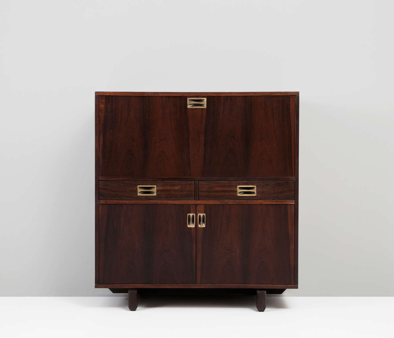 High sideboard with solid brass handles attributed Ico Parisi.

Minimalistic designed sideboard with well made handles which have carefully designed out of solid brass. The sideboard contains three storage options and two rosewood drawers.
