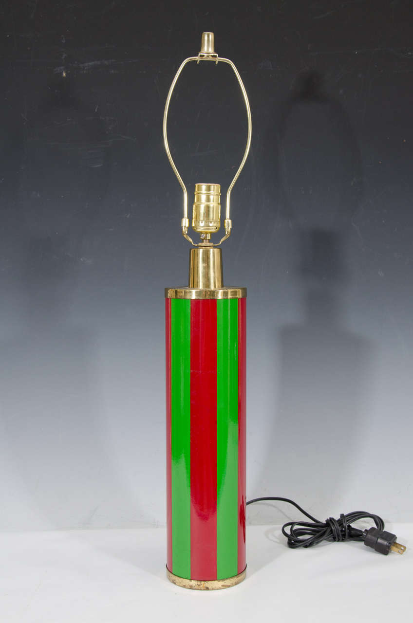 A vintage Fornasetti green and red glass table lamp. There is a label on the front that reads 