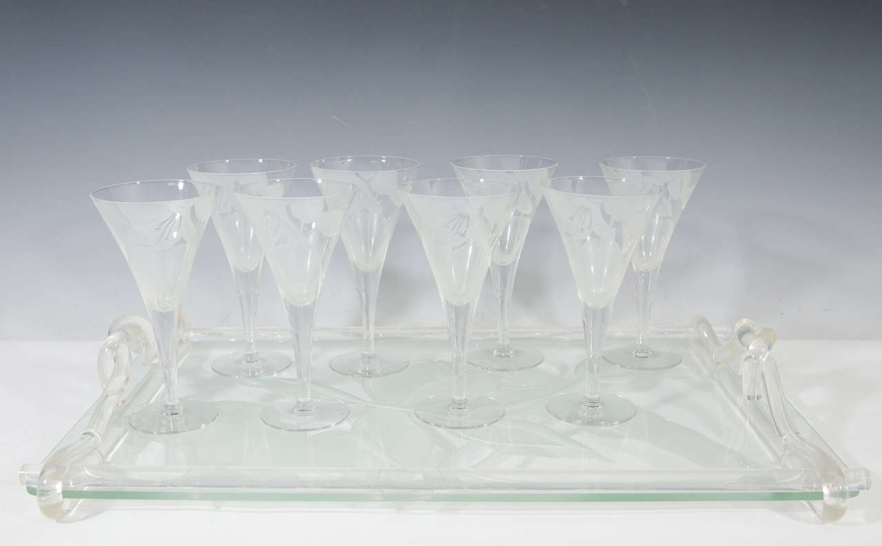 A vintage set of eight Dorothy Thorpe etched glass trumpet goblets with floral design, and an etched glass serving tray with Lucite handles. Tray is marked.

Good vintage condition with age appropriate wear. Some light scratching to glasses and