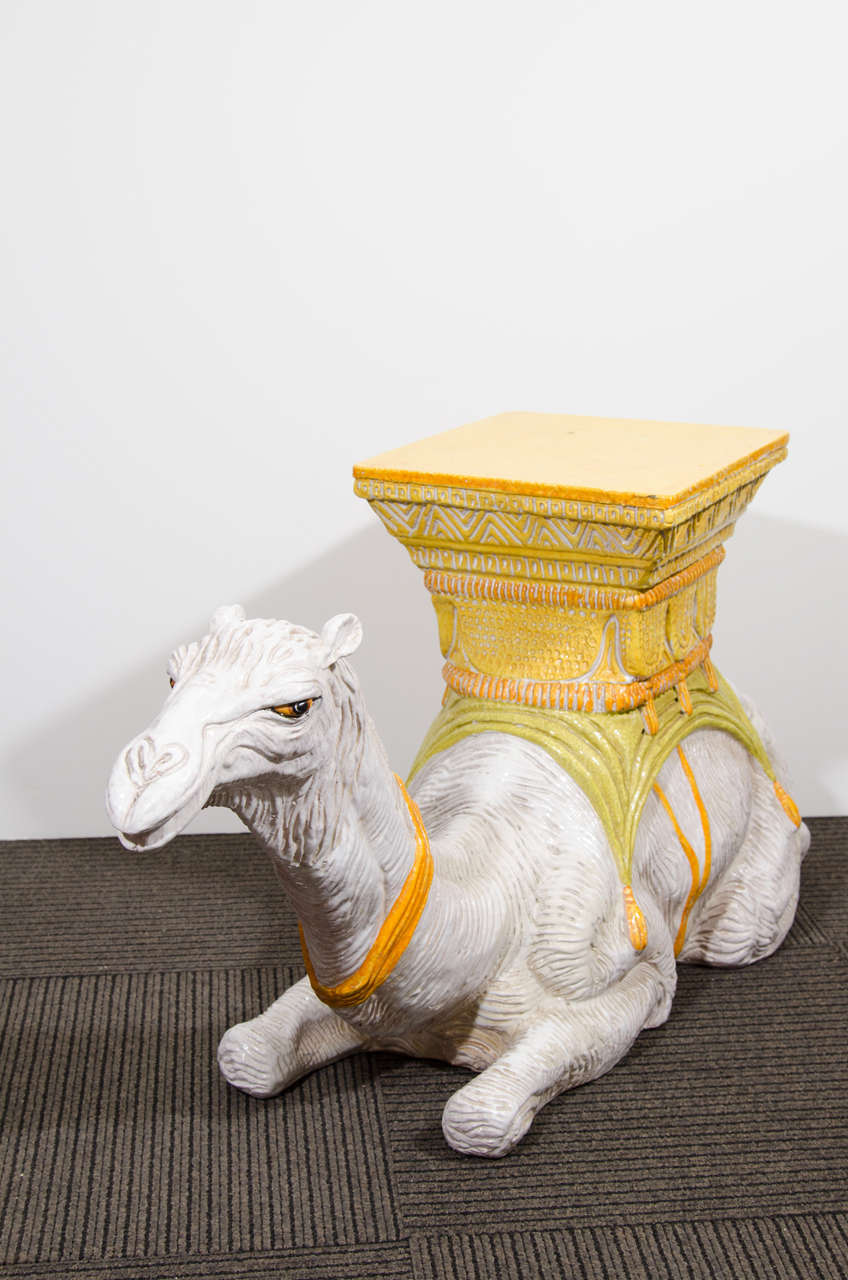 A fabulous vintage hand-painted Italian ceramic sculptural camel garden seat, circa 1970s.

Good vintage condition with age appropriate wear. All-over craquelure. Some small chips to the seat. A more significant chip to the base and some chips to