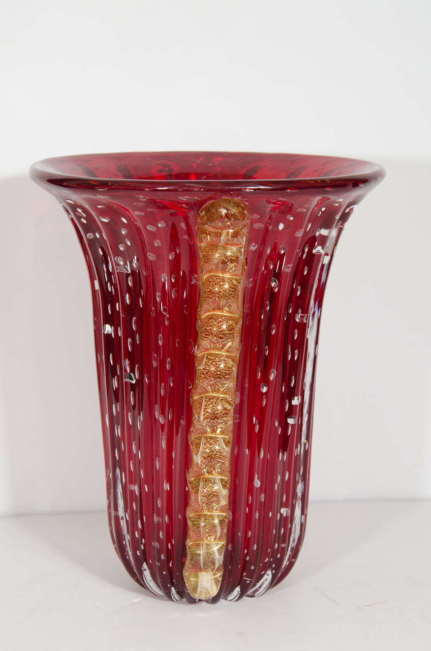 A vintage Barovier & Toso cranberry glass vase with 24K infused glass ribbons running down each side. Signed on the bottom.