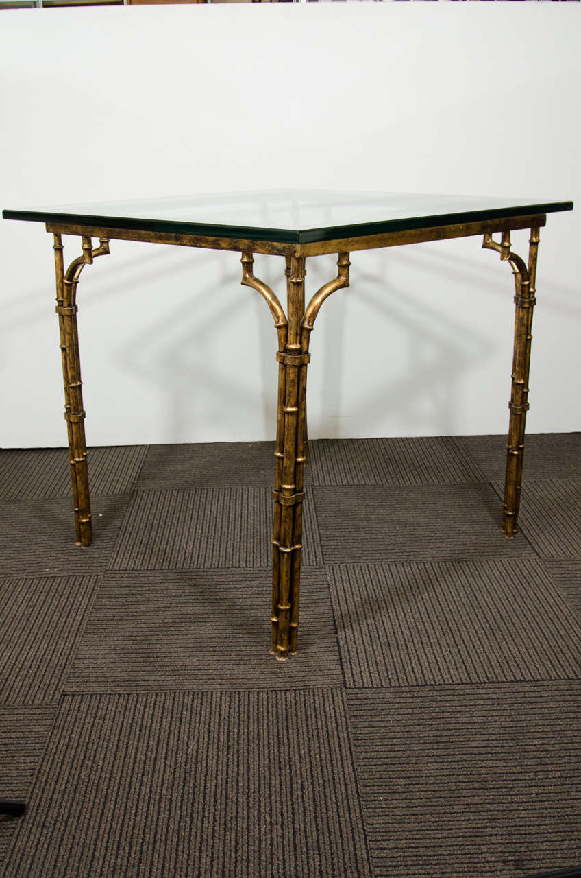 A vintage faux bamboo card table with thick glass top on gold leaf metal base by LaBarge, produced circa 1960s to 1970s. Good vintage condition with age appropriate wear and patina.