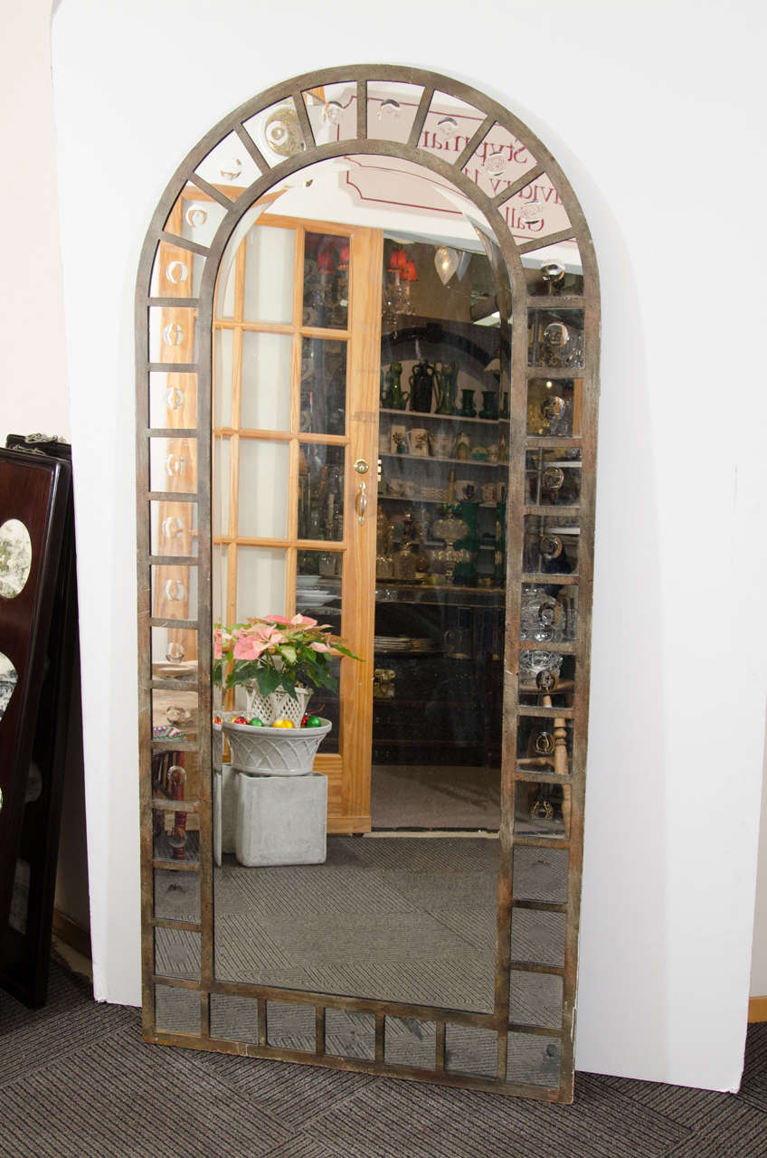 Industrial Modern arch shaped mirror with painted steel frame. Each square mirrored piece around the frame is decorated with a concave circle in the center. Good vintage condition with age appropriate wear and patina. Some silvering to mirror and