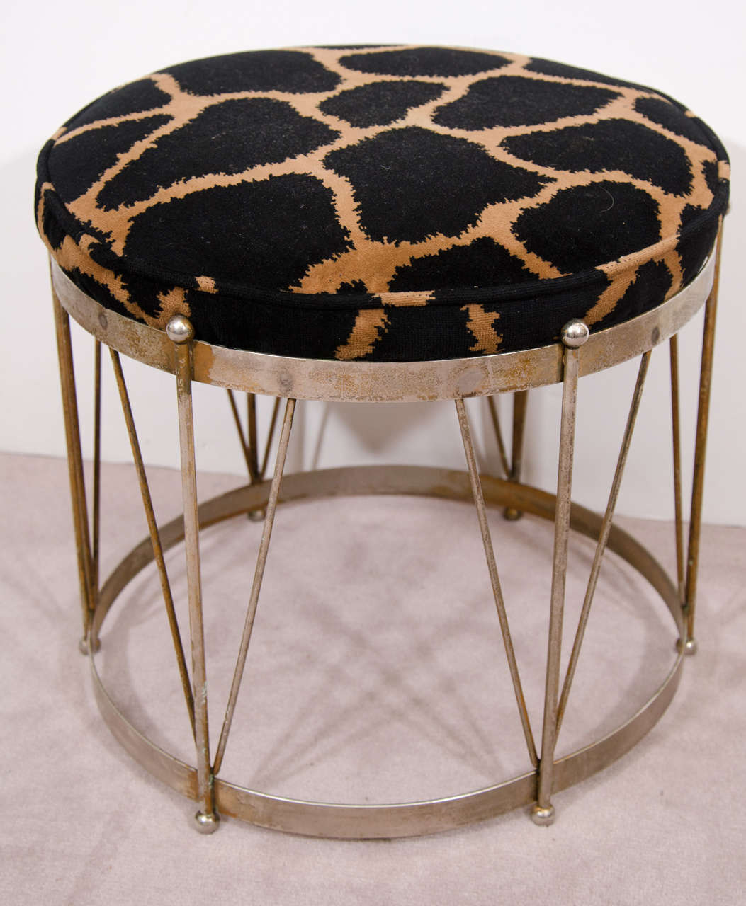A vintage plated metal drum style stool with black and brown animal print upholstery.

Good vintage condition with age appropriate patina. Some wear to chrome finish.
