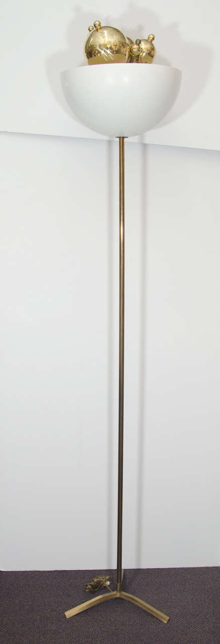 A vintage rare brass Italian sculptural torchiere floor lamp with cream enameled shade and five ornamental brass balls protruding from the top in the manner of Angelo Lelli, circa 1950s.