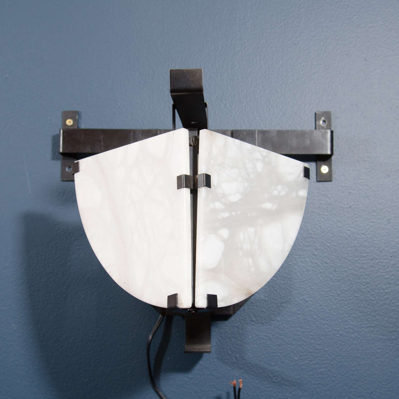 A 20th century "Potence" wall sconce in alabaster and black steel originally designed by Pierre Chareau.