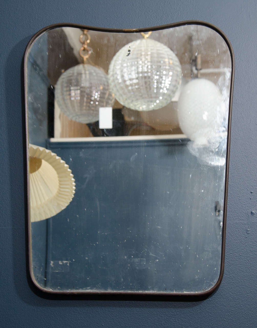 A vintage Italian wall mirror, circa 1950s. The brass frame has its original glass. Good vintage condition with age appropriate wear and patina. Some silvering.