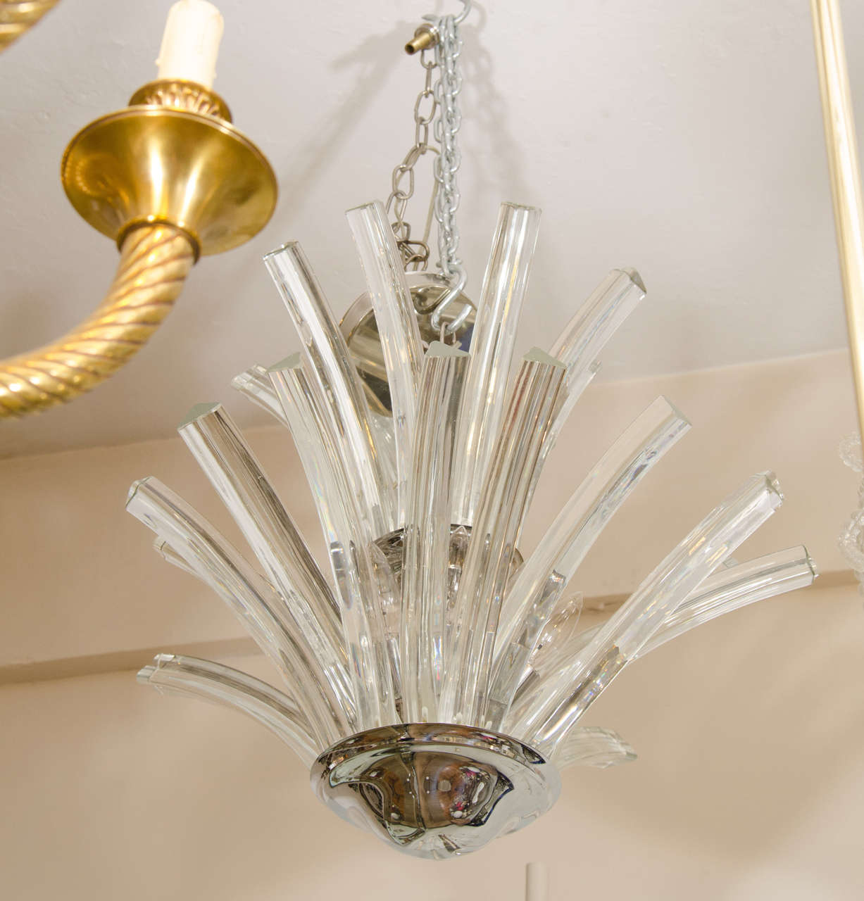 A 20th century two-tier Murano chandelier with tri-pointed curved glass rods. This chandelier takes nine candelabra base bulbs.