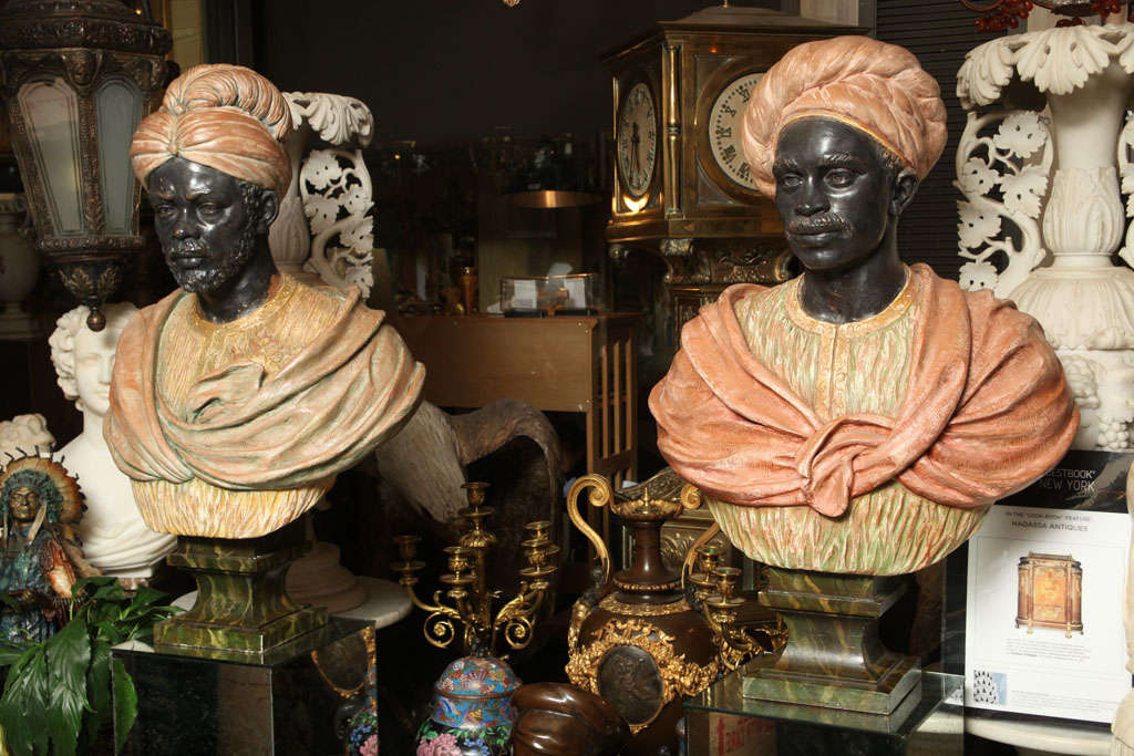 Pair of painted Plaster Figures of Nubiens on Mirrored Pedestals, 77