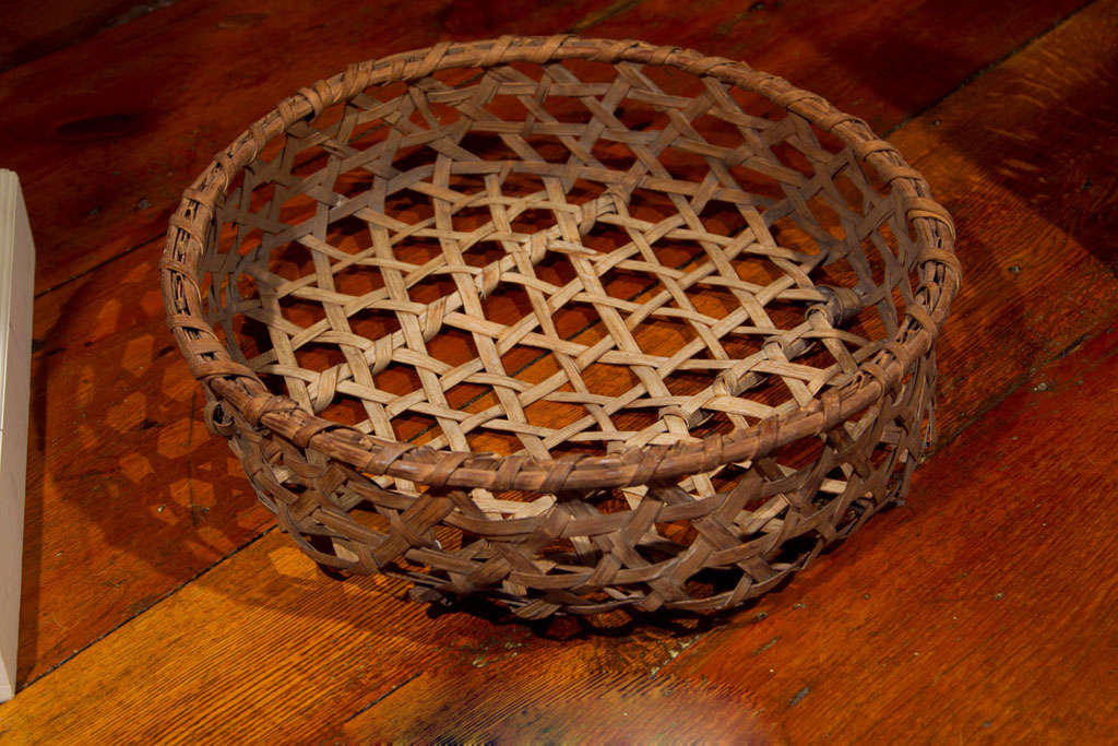 This is a very nicely woven sturdy cheese basket with a rich patina. It is constructed of ash splint and has two wooden runners along the bottom. These large baskets processed cheese products and were used in the dairies to separate the curd from