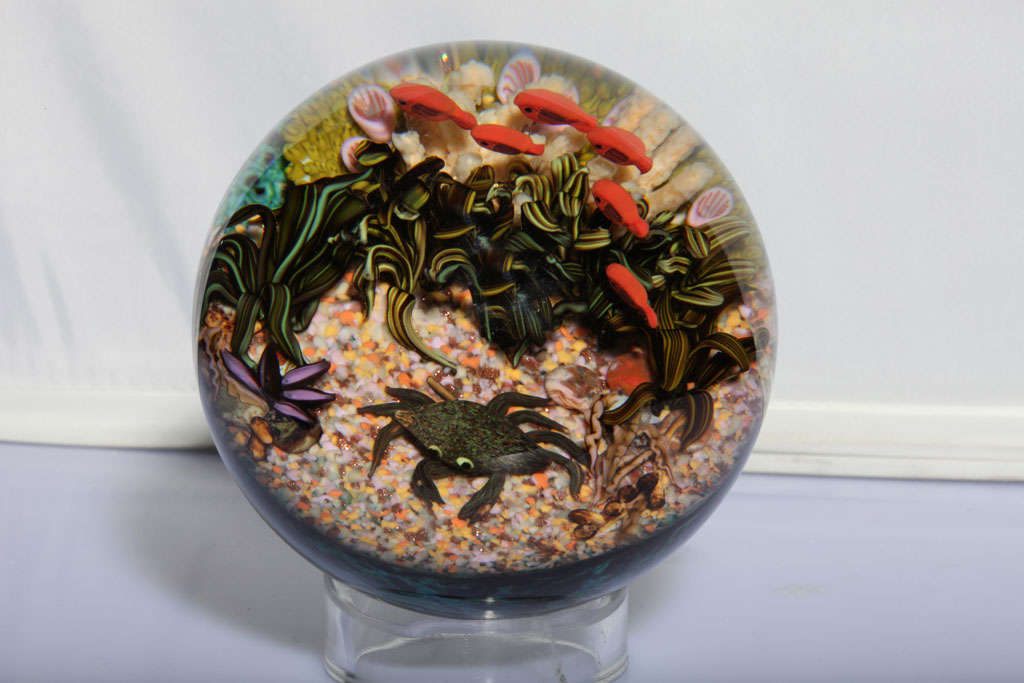 A fine Cathy Richardson magnum sea life paperweight with orange fish, a crab, sea plants and coral