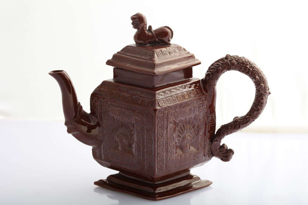 A rare and fine English glazed redware pottery diamond shape teapot with pectin shell design