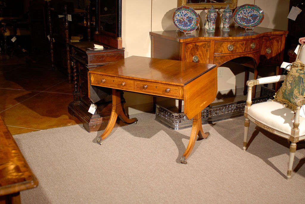 An English sofa Table in briarwood with inlay, 2 sliding drawers and stretcher below.  All resting on spayed legs with castors. <br />
<br />
For many more fine antiques, please visit our online gallery at: www.williamwordantiques.com<br />
<br