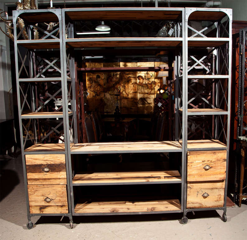 Intriguing Industrial entertainment center, steel frame with wood tops, raised on wheels. This piece can be taken apart for convenient shipping.