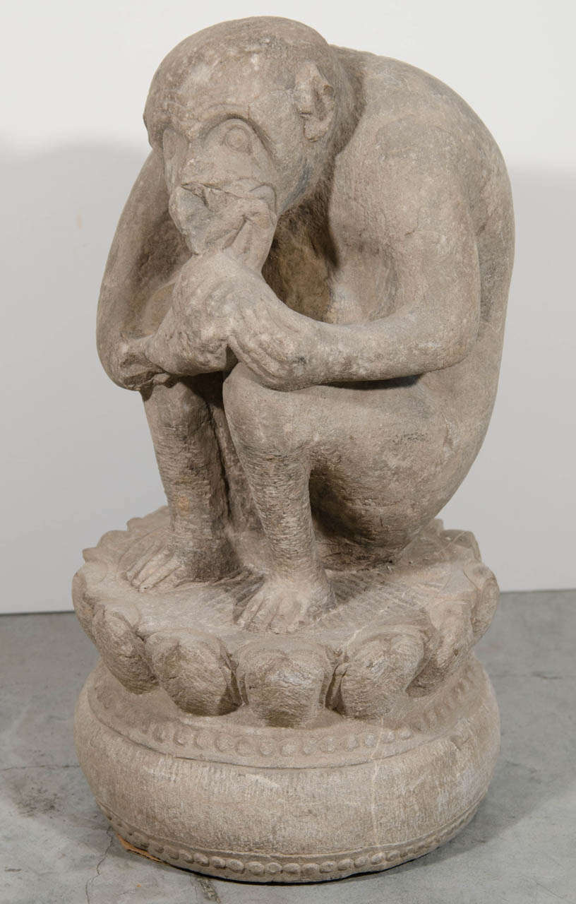 A nicely carved and unusual image of a contemplative crouching monkey. Carved out of a single piece of stone. China, Shanxi Province, c. 1850.
M721