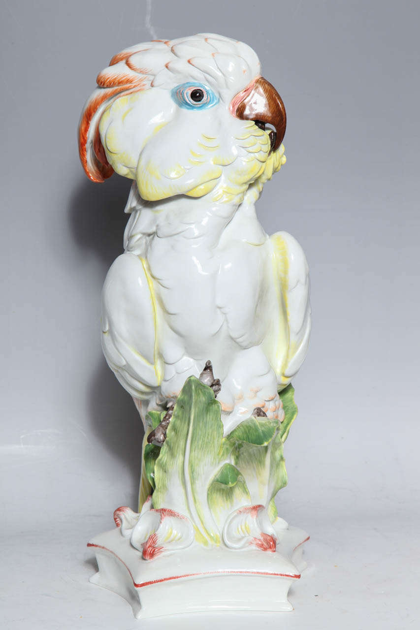 A delicately colored Large Meissen Porcelain Model of a Cockatoo, with underglazed blue pfeiffer crossed swords with incised lines. Signed PW (1924-1934) at the base. Modelled by Wather as perched bird on a on pentagonal base.