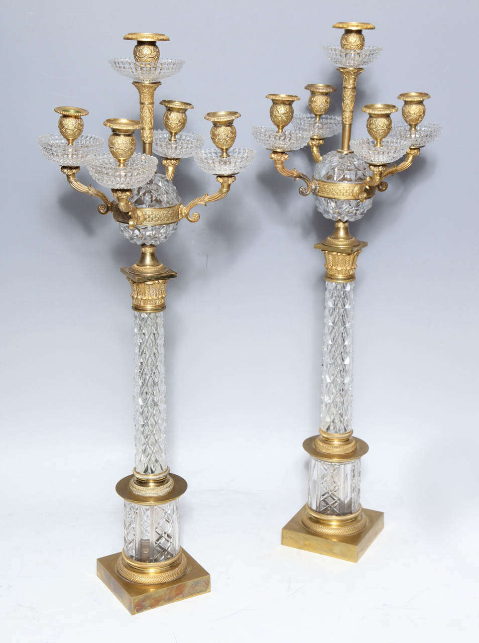 A pair of finely crafted Russian diamond-patterned cut-crystal five-light candelabra mounted and embellished with finely chased doré Bbonze mounts, from the early 1800s. These rare candelabra are attributed to the Imperial Russian Glass Manufactory,