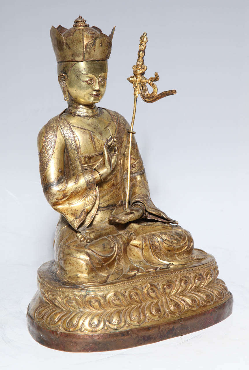 A 17th-18th Century Tibetan Gilt Bronze Crowned Seated Buddha Tibetan Gilded Copper Buddha is an Excellent Piece that shows the distinctly Tibetan Style that developed due to the country's physical and religious isolation. While the meaning of the