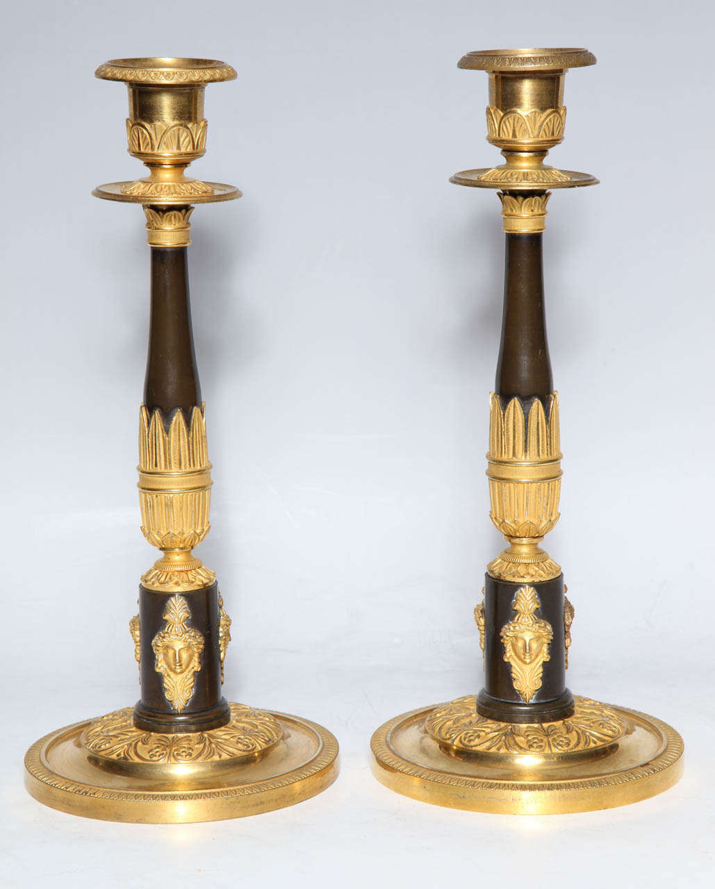 A Very Fine pair of Antique Russian, Empire Period, Two Tone Patinated and Dore Bronze Figural Single Light Candlesticks. Hand crafted from high quality Dore Bronze with exquisite gold detailing. These candlesticks are a fine example of the Empire