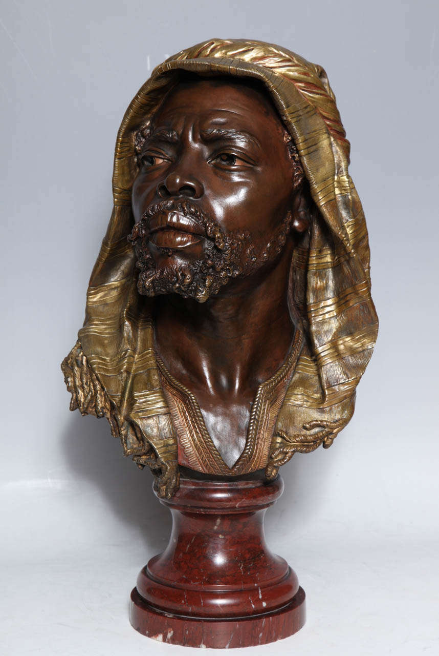 E. Guillemin, (1841-1907) A very Important and quite Unique, Antique French Bust of a Nubian in Original Gilt and Patinated Bronze, finely mounted on an original Rouge Marble Base.
It is important to note the Superb quality of the cast and hand