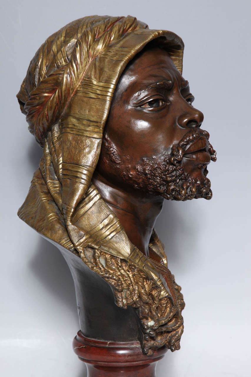 E. Guillemin, (1841-1907) An Antique French Bust of a Nubian in Original Gilt and Patinated Bronze mounted on Rouge Marble Base 1