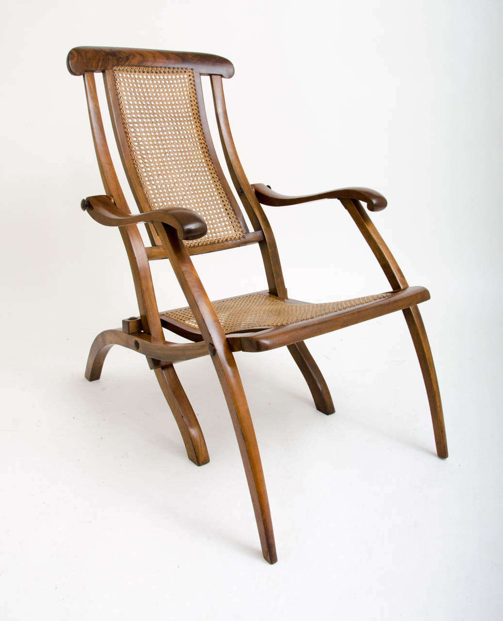 A 19th Century steamer chair with cane seat.