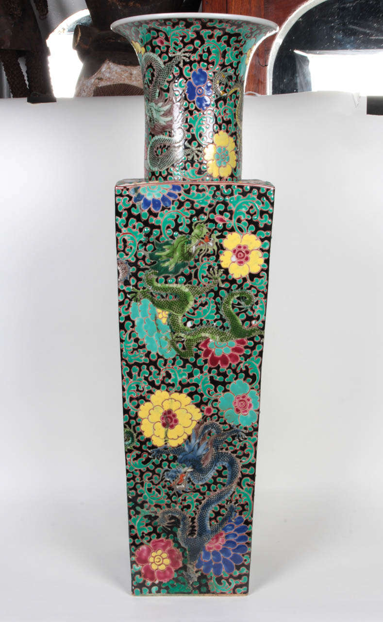 Pair of Yongzheng-style, Chinese porcelain floor vases.  China, late 20th Century.  Densely decorated with Famille Rose enameled millefleur pattern over a black ground, featuring colorful floral blossoms.  29.5 inches tall.