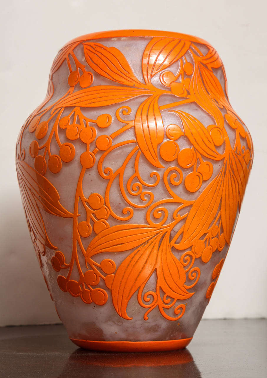 A very rare and important Daum Art Deco Vase from c. 1925, with beautiful bright orange enamel decoration of branches and berries, acid etched  on opalescent background, signed at the base Daum Nancy with the Cross of Lorraine.
Literature: