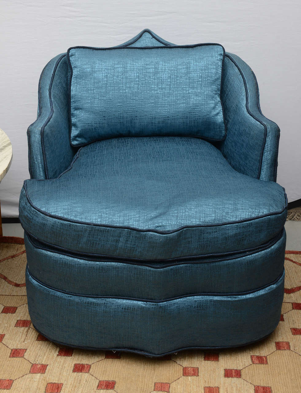 Beautiful sapphire blue Moroccan swivel chair with contrast darker piping.  Chair is on wheels and swivels.  1969