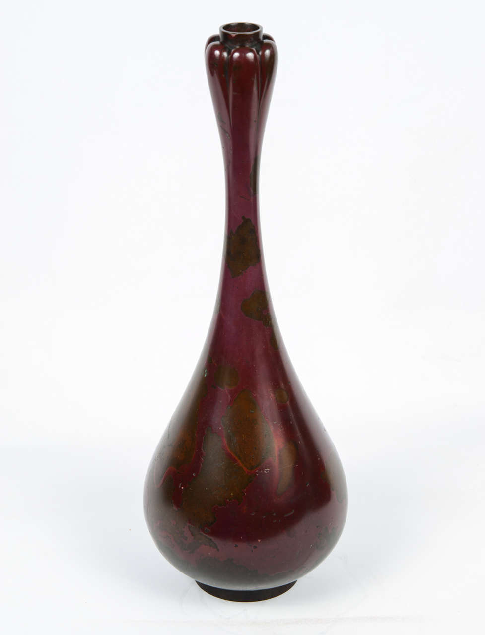 Bronze vase with red patina and long shaped neck known as 'garlic clove.'